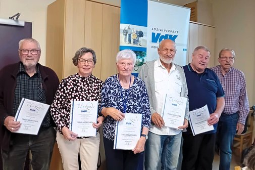 Gruppenfoto von Frauen und Männern mit Urkunden-