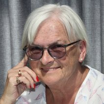 Eine lächelnde würdevolle Dame mit Brille
