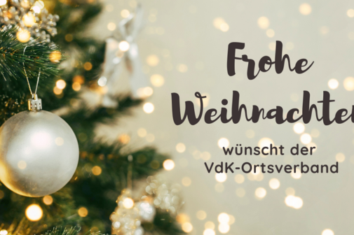 Weihnachtskugel an einem Tannenbaum und der Schriftzug: Frohe Weihnachten.