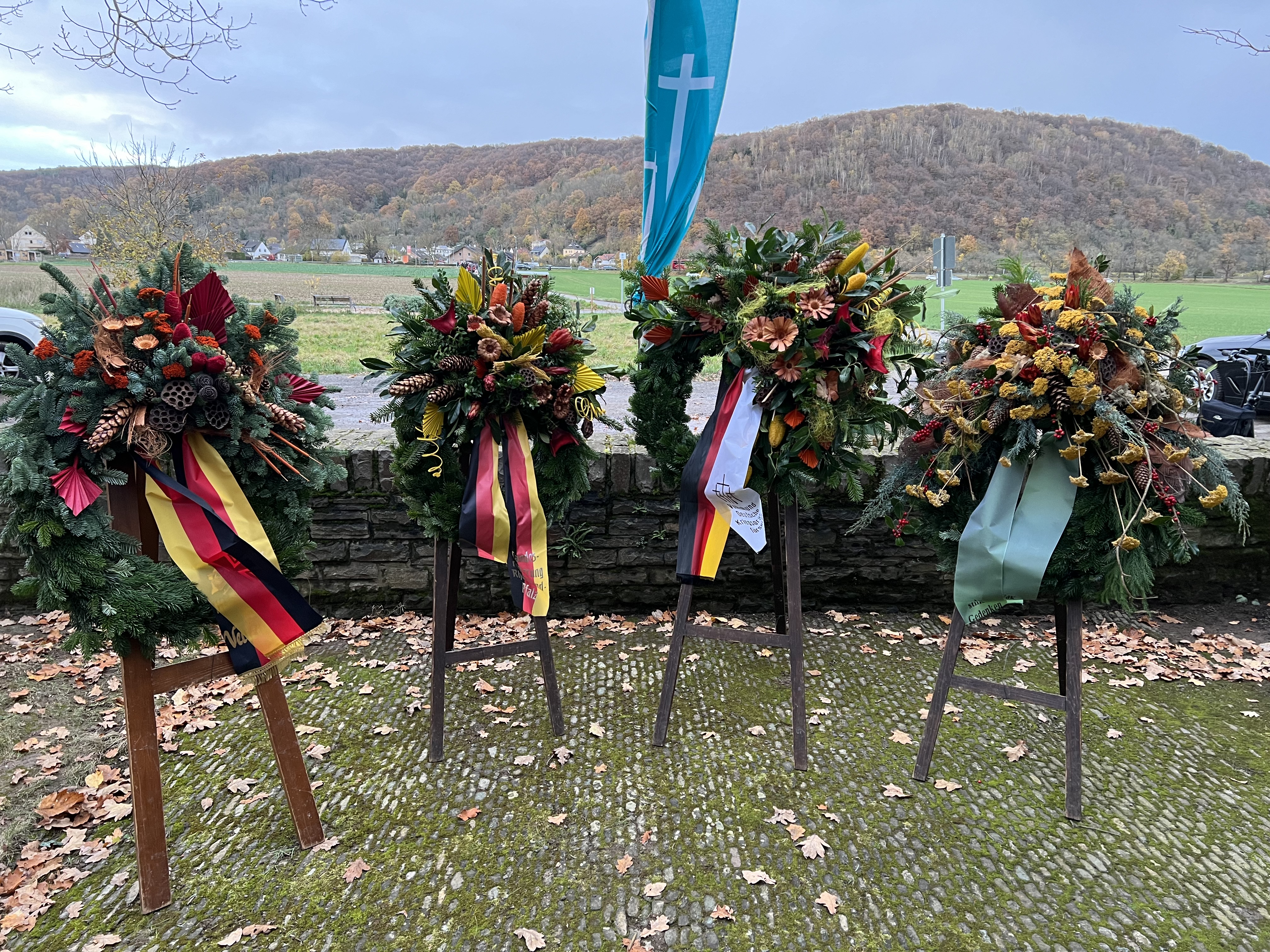 Vier Kränze stehen auf Ständern auf dem Soldatenfriedhof in Bad Bodendorf.